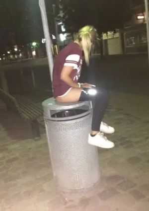 Up on the trash to pee