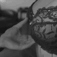 Grabbing her by her bra…