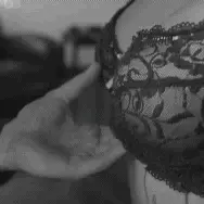 Grabbing her by her bra…