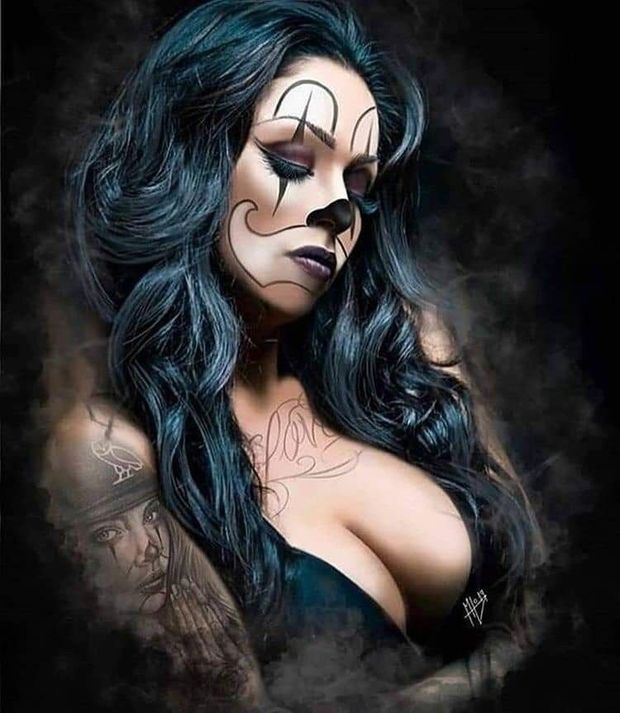 Beautiful jet black hair goth in clown makeup.