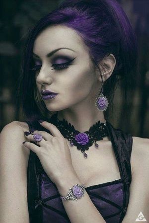 Beautifully done makeup goth and attire of black sackcloth and Royal Purple.