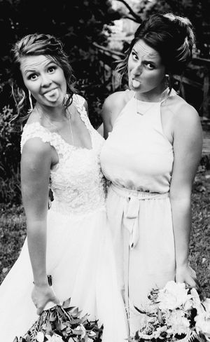 The 2 brides pose for pictures, not knowing what will happen to them both later that night