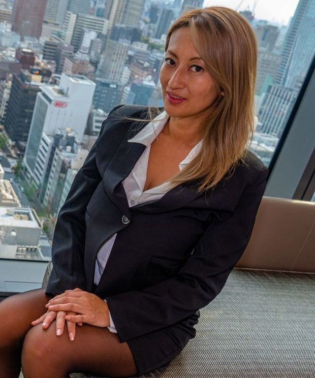 Japanese Business Lady Rena Randy in her Flat in front of panoramic City View
