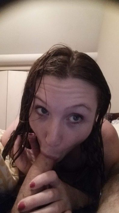 Amateur brunette with wet hair sucking on cock