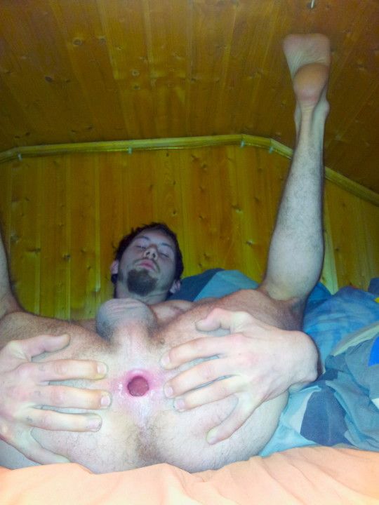 Spreading his gaping pleasure hole