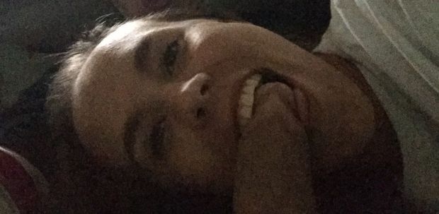 Amateur brunette taking a selfie with a cock happily in her mouth