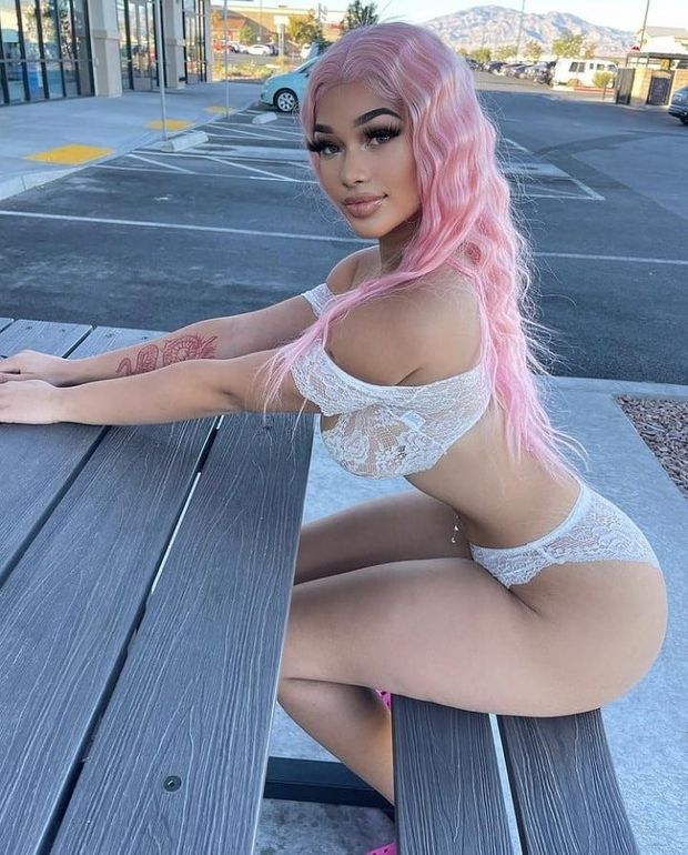 Lexie pink hair sitting at picnic table