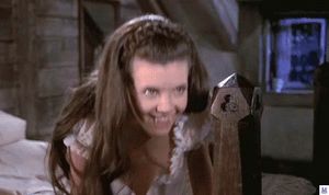 One of the twins showing her sexy tits, stomach, belly and a touch of pussy.