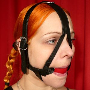 Submissive controlled with head harness gag