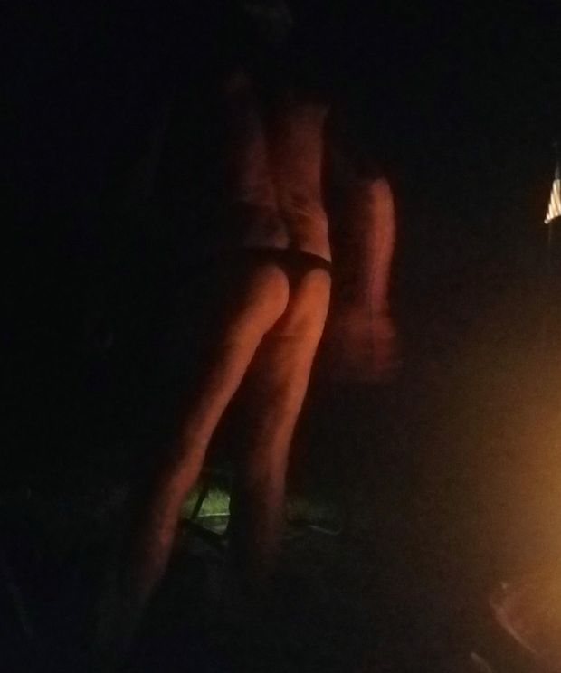 Ass in thong by the fire