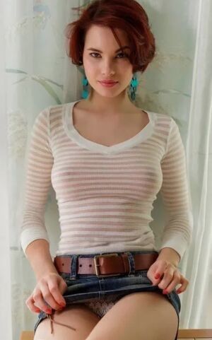 Sexy redhead in a short denim upskirt