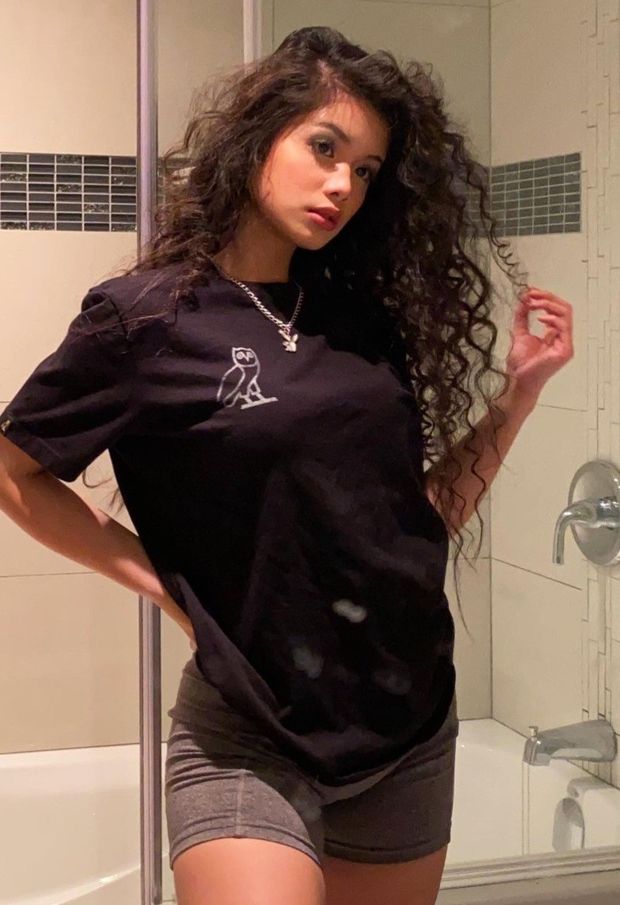 Sam curly hair in bathroom touching