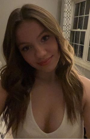 Blonde showing cleavage in white top