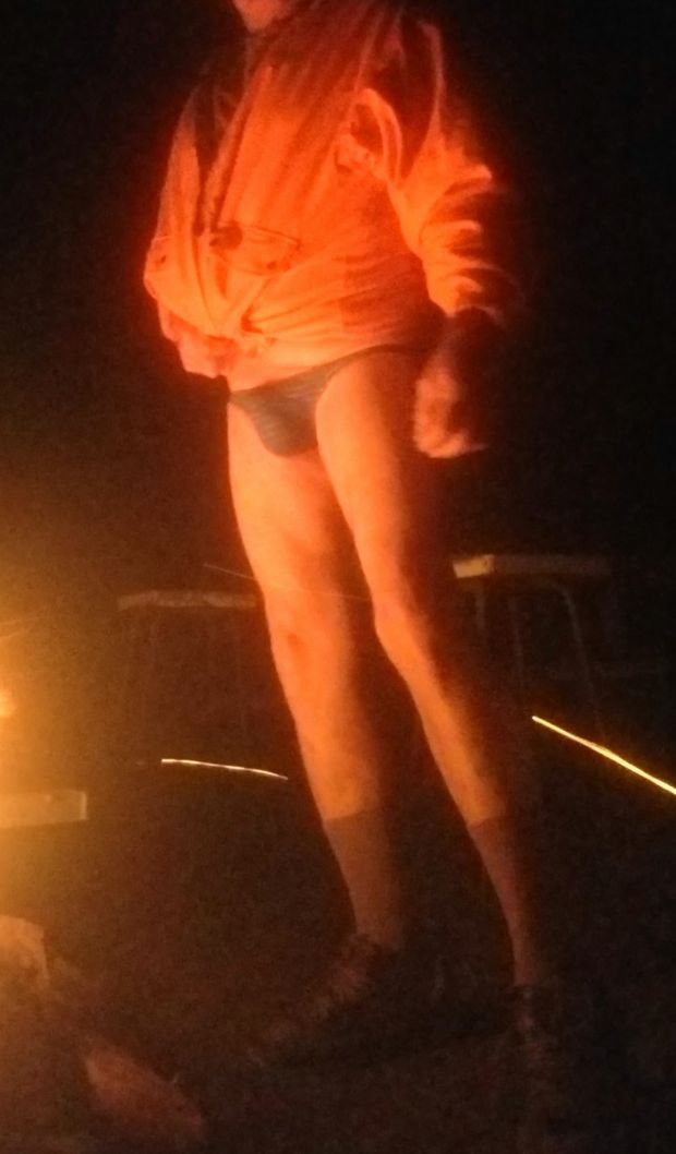 Bulging in thong by the fire camping