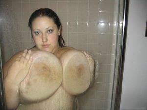 Huge tits against glass shower door
