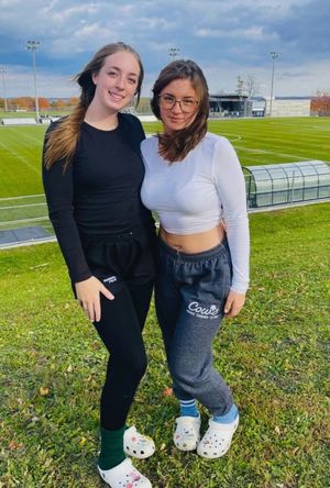 Two cuties outside athletic field