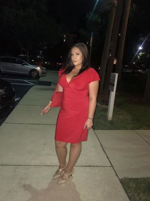 Slutty lil Laura Reed poses in a sexy lil red dress