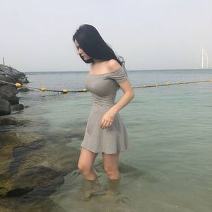 Eve Gross tight grey dress at sea