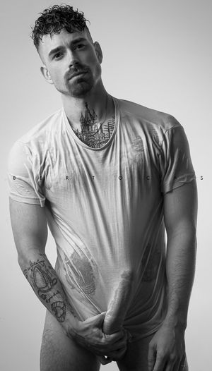 Dude holding his erect boner behind his wet t-shirt: Alberto Casu portrait photographer