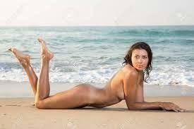 Sun warms her rump-sand warms her crotch