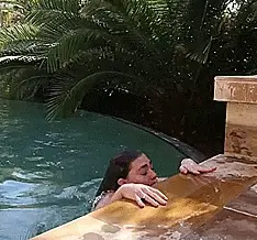 Hottie launches herself out of the pool & her topless titties bounce & jiggle all over the place
