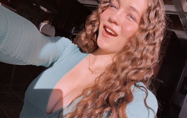 Redhead blue top cleavage