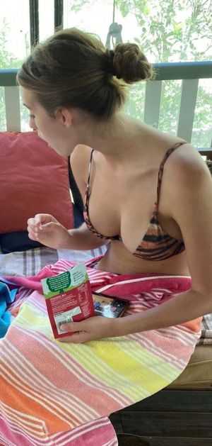 Emily leaning over bikini top