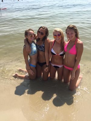 Babes kneeling in the sand