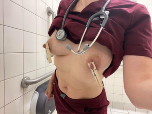 Nurse pinching her nipples