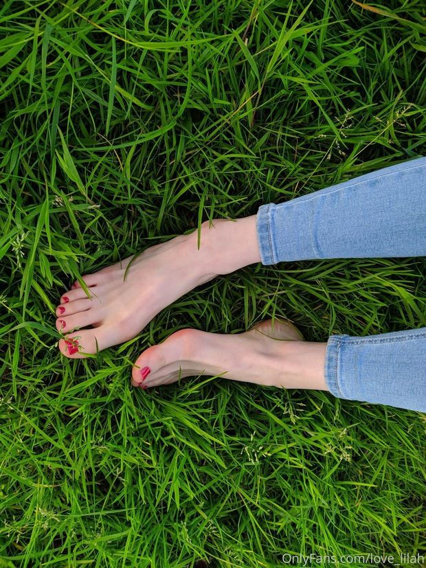 Pale skinny feet in grass