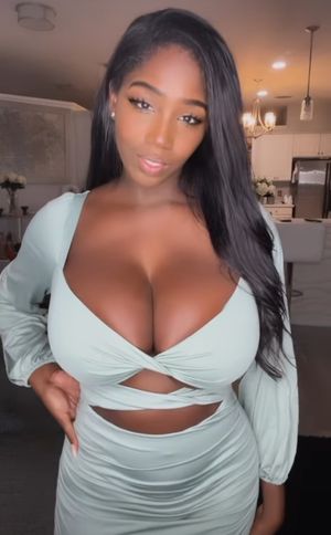 Ellie Mae in green dress in living room 2