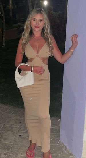 Claire in tan dress cleavage