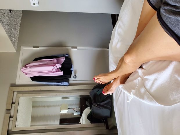 Nice legs and feet, resting on hotel bed.