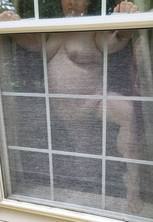 BBW poses naked in window flashing her big beautiful body