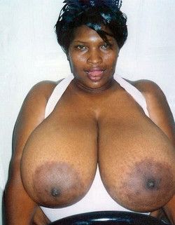 Showing off her gargantuan breasts