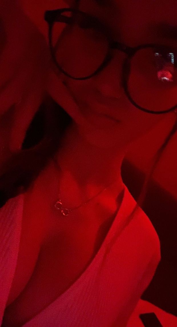 Alexa W in red light and glasses