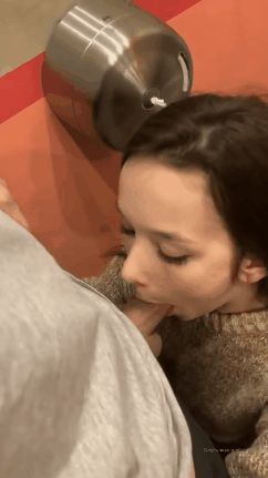 Teen cutie getting her mouth fucked in a public bathroom
