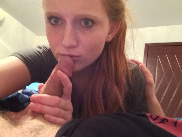 Amateur redhead giving a blowjob to an average-sized dick