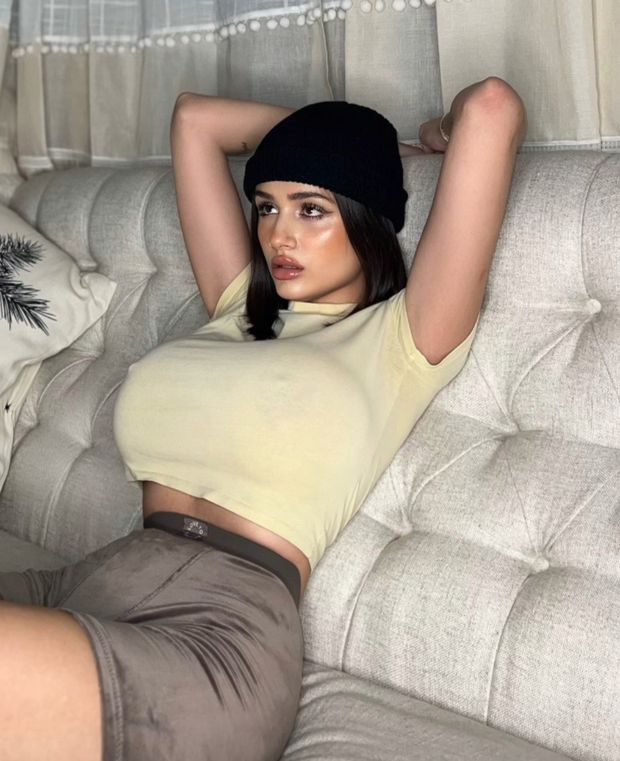 Julia T reclining on couch with pokies