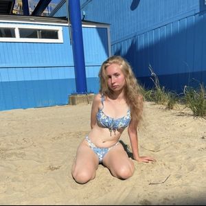 Beautiful blonde bikini babe on her knees