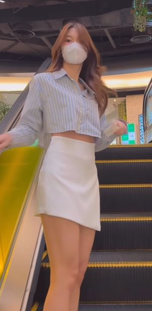 Beautiful asian whore on escalator