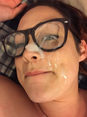 Brunette amateur with glasses with cum on her face