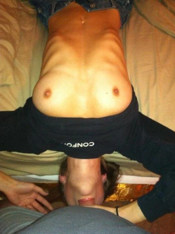 Great shot of an amateur brunette giving a lie back blowjob