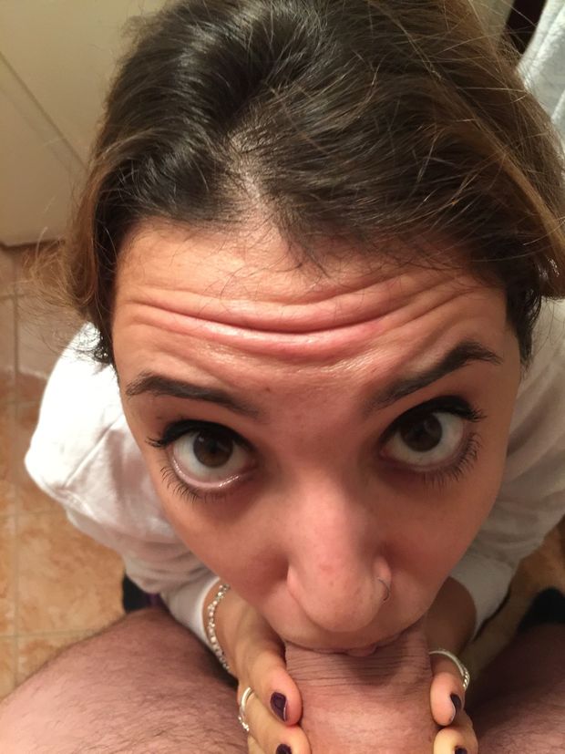 Doe-eyed amateur brunette sucking on a cock