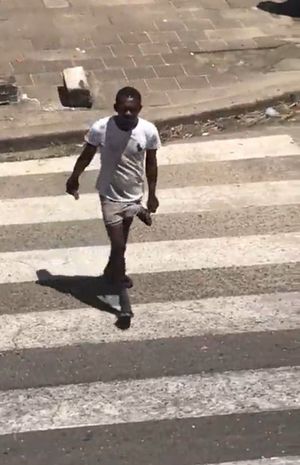 African's huge monster cock comes out of his shorts while crossing the street. Mmmm.