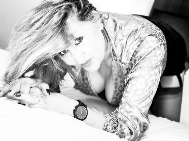 Bending over, Smiling with excitement and anticipation in a hotel room waiting for the first of 5 strangers to enter and fuck her