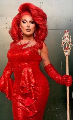 Lovely redhead in a red dress .