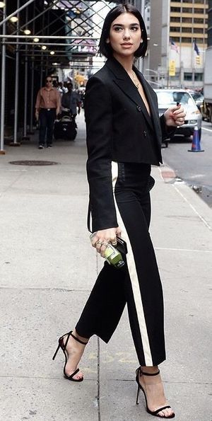 Short-haired Dua Lipa rocking a sexy elegant suit outfit
