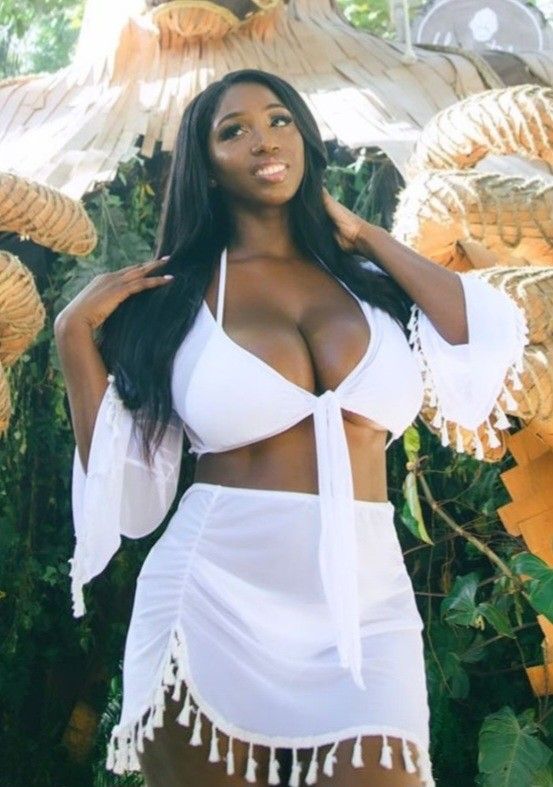 Ellie Mae white outfit in front of mural
