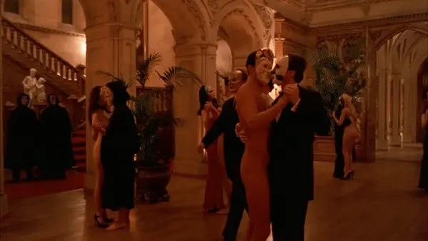 Lesbian and gay couples enjoying their time at a perversed party in a ballroom - Eyes Wide Shut Orgy